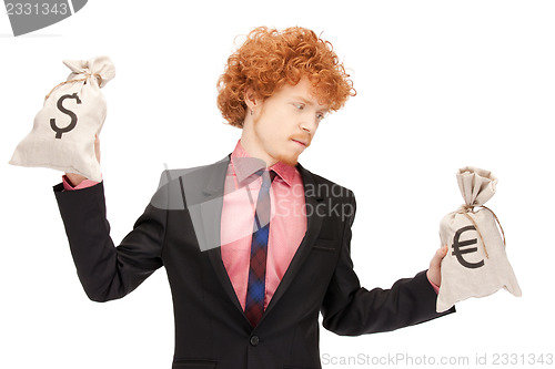 Image of man with euro and dollar bags