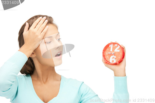 Image of woman holding alarm clock