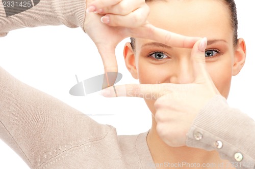 Image of lovely woman creating a frame with fingers