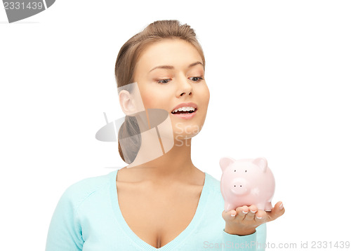 Image of lovely woman with piggy bank