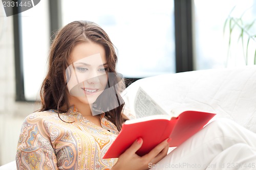 Image of happy and smiling woman with book