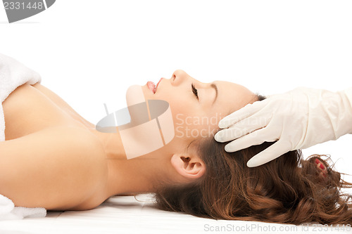 Image of beautiful woman in massage salon