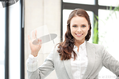 Image of lovely teenage girl showing ok sign