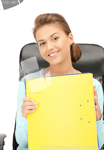 Image of young businesswoman with folders sitting in chair