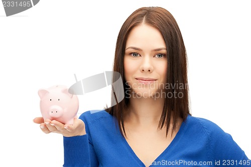 Image of lovely woman with piggy bank