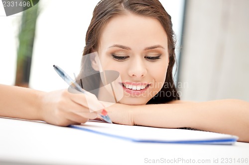 Image of happy woman with big notepad