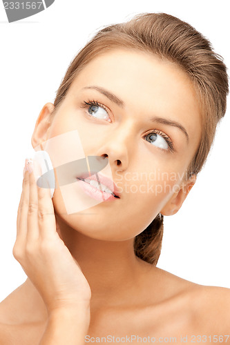 Image of beautiful woman with cotton pad