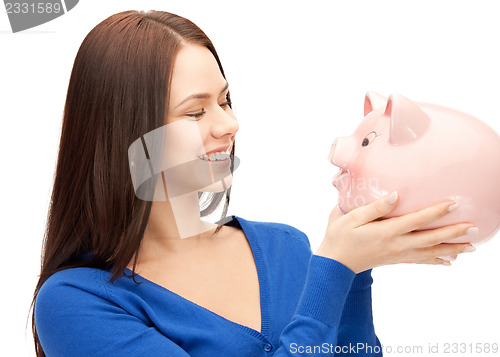 Image of lovely woman with piggy bank