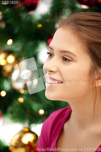 Image of happy and smiling woman with christmas tree