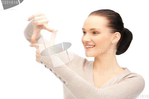Image of lovely woman creating a frame with fingers