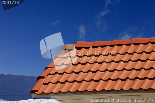 Image of Roof tiles against ski slope in nice day