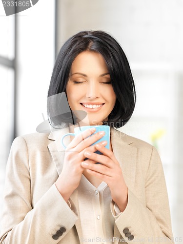 Image of lovely businesswoman with mug