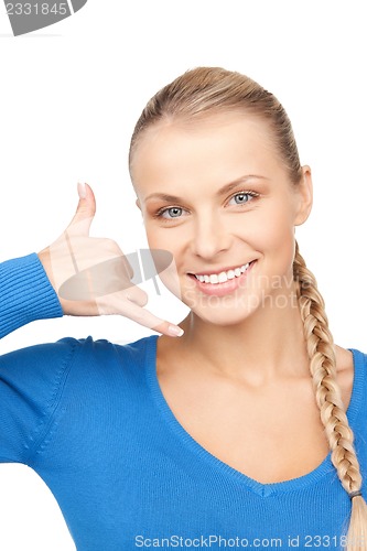 Image of woman making a call me gesture