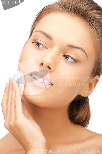 Image of beautiful woman with cotton pad