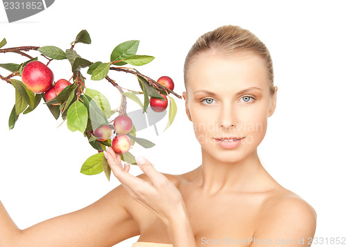 Image of lovely woman with apple twig