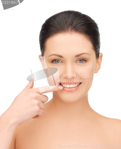 Image of beautiful woman pointing to teeth