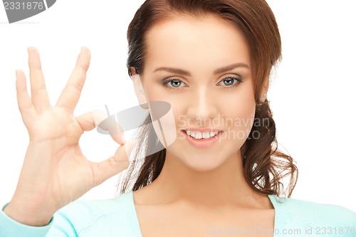Image of lovely teenage girl showing ok sign