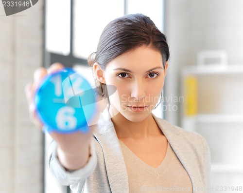 Image of businesswoman with clock