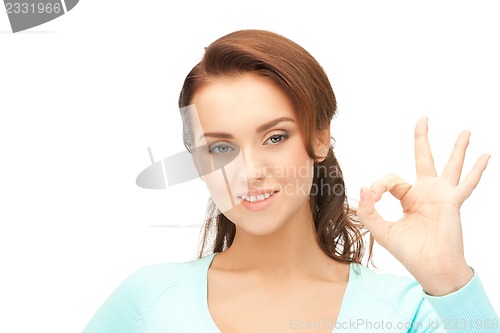 Image of lovely teenage girl showing ok sign