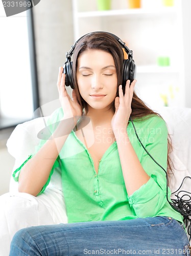 Image of happy teenage girl in big headphones