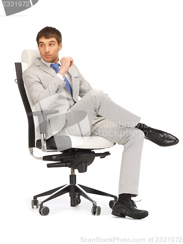 Image of young businessman sitting in chair