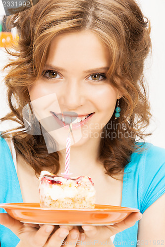 Image of lovely housewife with cake and candle