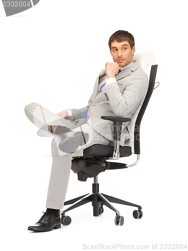 Image of young businessman sitting in chair
