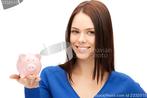 Image of lovely woman with piggy bank