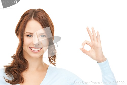 Image of lovely teenage girl showing ok sign