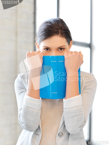 Image of calm and serious woman with book