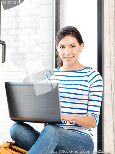 Image of happy teenage girl with laptop computer