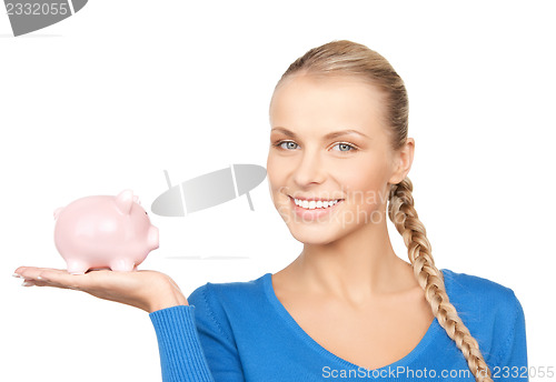 Image of lovely woman with piggy bank