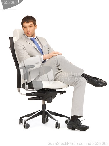 Image of young businessman sitting in chair