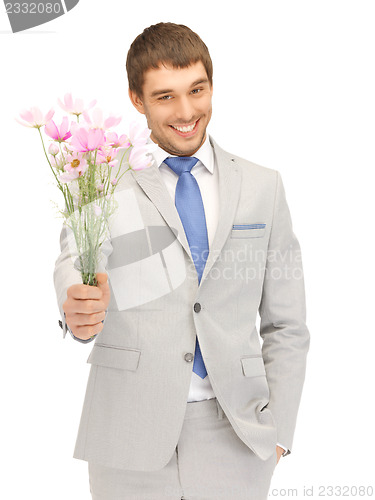 Image of handsome man with flowers in hand