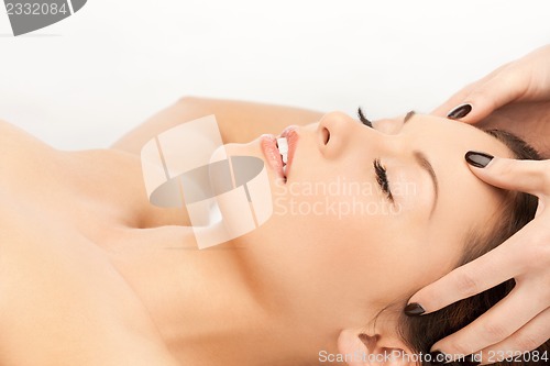 Image of beautiful woman in massage salon