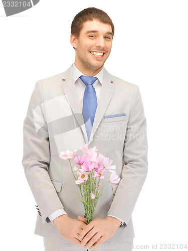 Image of handsome man with flowers in hand