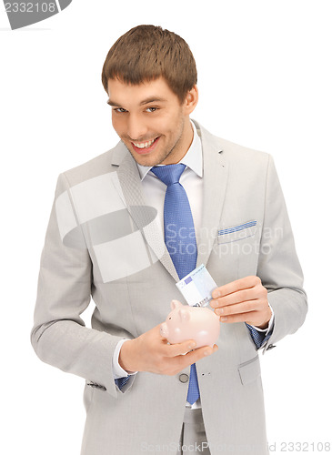 Image of man with piggy bank and money