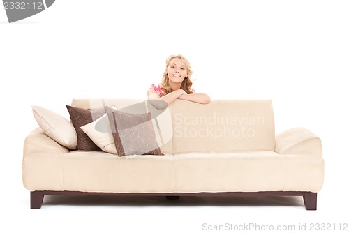 Image of happy woman on sofa