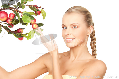 Image of lovely woman with apple twig