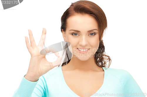 Image of lovely teenage girl showing ok sign