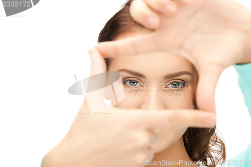 Image of lovely woman creating a frame with fingers