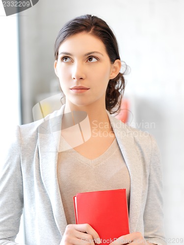 Image of calm and serious woman with book