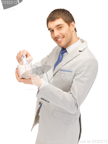 Image of man with piggy bank and money