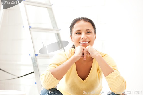 Image of lovely housewife making repairing works