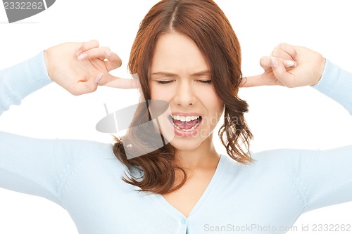 Image of woman with fingers in ears