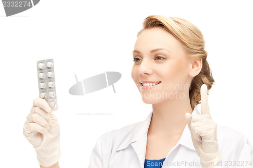 Image of attractive female doctor with pills