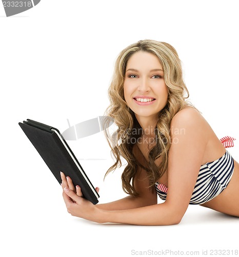 Image of woman in bikini with tablet pc computer