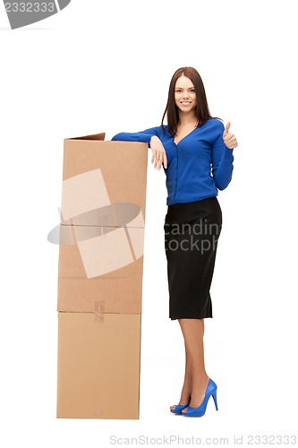 Image of attractive businesswoman with big boxes