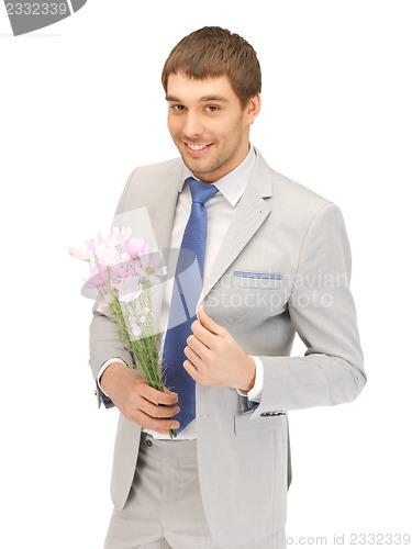 Image of handsome man with flowers in hand