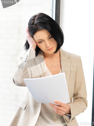 Image of calm woman with documents